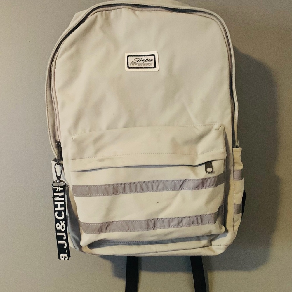 Backpack with charging port and cord for phone.